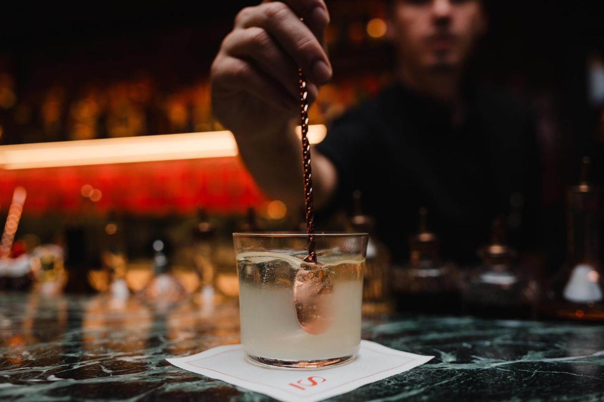 Sly Berlin Hotel Ngoại thất bức ảnh A bartender adding a garnish to a cocktail